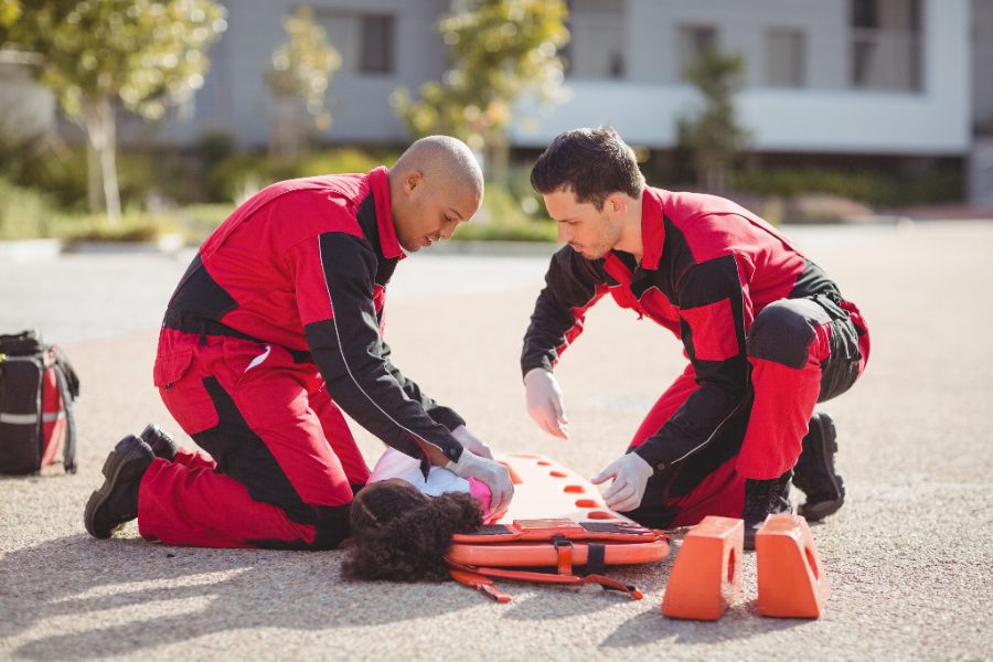 Paramedics demonstrating a backboard rescue